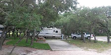 Rv sites in the trees at Enchanted Oaks RV Park in Rockport, TX